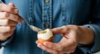 © Nasrin - Hard boiled egg preparation with spoon and blue denim shirt