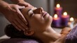 © CStock - A serene woman enjoying a relaxing head massage with candles in the background, promoting wellness and tranquility.