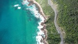 Coastal road on the beautiful ocean coast of Australia. Blue sea and wild coast view from above.