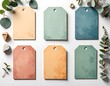 © galang - Pastel tags arrayed w/stones & eucalyptus on white backdrop