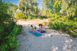 © dizfoto1973 - Two people practice yoga outdoors on sandy ground amidst lush green trees, embracing nature and healthy living. A serene scene of mindfulness and fitness in a peaceful natural environment.