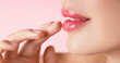 © New Africa - Woman with beautiful lipstick on her lips against pink background, macro view