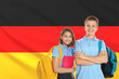 © New Africa - Students with backpacks against flag of Germany. Language school