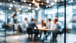 © ttonaorh - a business team is having a meeting in a conference room with glass walls. the background is blurred, and there is a bokeh effect of the office building outside the window.