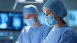 © Sergio - Two healthcare professionals in surgical attire focus intently during a procedure, showcasing a sterile and professional medical environment.