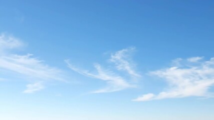 Wall Mural - High altitude cirrus clouds streak gracefully across a clear, pale blue sky with elegant motion graceful, slow motion, serene