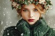 © Yana Gavriloski - A young woman with striking green eyes and freckles stands in falling snow. She wears a cozy green sweater and a floral crown, capturing the magic of winter and the holiday spirit