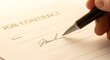 © Helen - A close-up shot shows a hand signing a job contract with a pen, emphasizing agreement and employment.