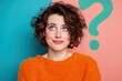 © teostudio - Woman with curly hair looking up with a question mark in the background.