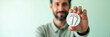 © Manu - A man is depicted holding a carbon reduction icon, emphasizing the carbon footprint concept. The arrangement uses negative space for added emphasis on sustainability.