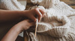 © Ventura - Knitting hands creating a cozy sweater
