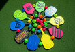 © Gunnar - Colorful pickleball paddles and balls arranged in a circle on turf