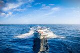 Front view of a sports RIB boat cruising with high speed over the cam ocean with copy space