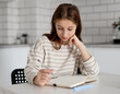 © tan4ikk - Teen Girl Thinking While Sitting Over Notes At Home