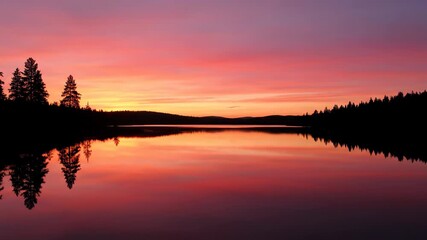 Wall Mural - serene lake reflecting a breathtaking sunset with vibrant colors across the still water, captured wi
