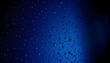 © Husen - Glistening water droplets beading on a dark blue textured surface fading into black.