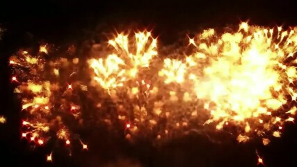Golden fireworks exploding in the night sky creating a beautiful and festive celebration scene