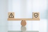 Risk assessment concept with cubes and icons balancing on seesaw in minimalist office