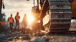 © Oleksandr - Heavy equipment track and construction workers create a dynamic scene against a sunset backdrop.