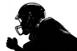 © Iftikhar alam - Realistic silhouette of a football player in a helmet preparing for action during a night practice session on the field