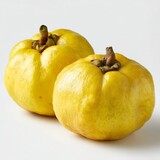 Two fresh Garcinia fruits, ripe and ready to be used. The fruits have a bright yellow skin