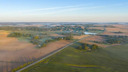 Wall Mural - Road Through Fields Near Remote Village On A Misty Morning. Timelapse