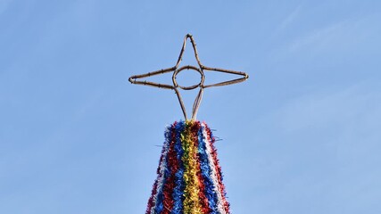 Wall Mural - Christmas tree decorated with star, colorful garlands in Tenerife Spain winter