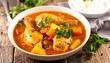 © wedang - Hearty chicken and vegetable stew in a white bowl