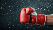 © siraphol - Close up of red boxing glove with water droplets, showcasing power and intensity