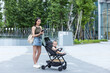 © leungchopan - Mother go outside with baby stroller in park