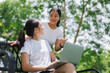© Phimwilai - Young women collaborating using laptop in park