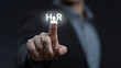 © Furkan - Businessman Touching Virtual HR Icon for Human Resources Management, Employee Engagement, Recruitment Strategy and Workforce Development