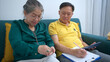 © Wosunan - On a holiday, an elderly couple keeping a record of household and personal income and expenses