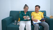 © Wosunan - On a holiday, an elderly couple keeping a record of household and personal income and expenses