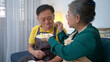 © Wosunan - On a holiday, an elderly couple tests out handmade desserts at home.