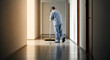 © Karmiyem - Hallway Cleaning Service Professionalism in Focus A Dedicated Janitor Maintaining Hygiene and Order in a Modern Interior Setting Professionalism Shining Through
