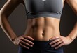 © Alper - Fit woman's toned abs and physique in a studio shot