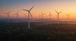 © Photyn Studio - An aerial view shows a wind turbine installed in a dense forest to generate renewable electricity. Concept of onshore wind power generation in forested areas.