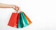 © ismail - Womans Hand Holding Colorful Shopping Bags Isolated on White Background Consumerism Concept Retail Therapy and Black Friday Deals for Shoppers