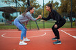 © Dexon Dee - Women friends making handshake on fitness court