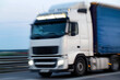 © HENADZY - Fast moving truck on highway during early evening hours, blurry