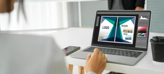 Graphic designer software for modern design of web page and commercial ads showing on the computer screen
