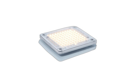 Wall Mural - A close-up of a square, silver electronic device, emitting a warm, grid-patterned light