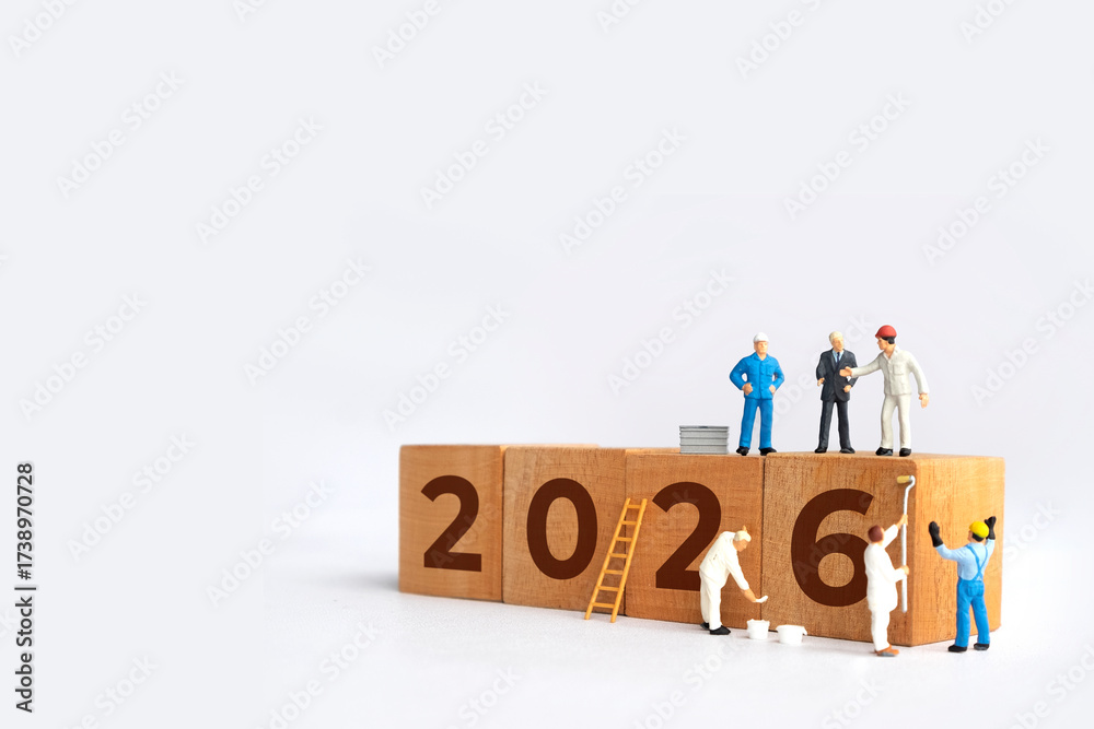 Transitioning from 2025 to 2026 with wooden blocks and miniature people ...
