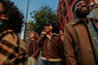 © bernardbodo - Group of young students walking and listening to music in the city
