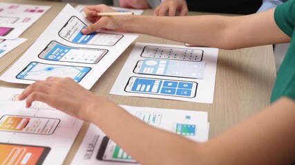 Panorama video of startup UX developer or company employee design user interface or UI prototype for mobile application or website software with software display on smartphone in office. Synergic