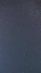 Wall Mural - Cloudy Night Starry Sky With Glowing Stars. Bright Glow Of Sky Stars And Milky Way Galaxy. 4K. Natural Background Backdrop. time lapse, timelapse, time-lapse