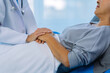 © ArLawKa - Doctor is examining elderly female patient in ward while doctor is checking her condition in recovery room. Medical and healthcare concept.
