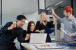 © NINENII - Diverse professionals collaborate on project analysis with financial graphs.