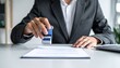 © NaimStock - A corporate worker applying a stamp to an official document in the office, Generated with AI.